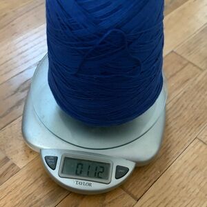 11.2 ounces bright blue yarn on a cone